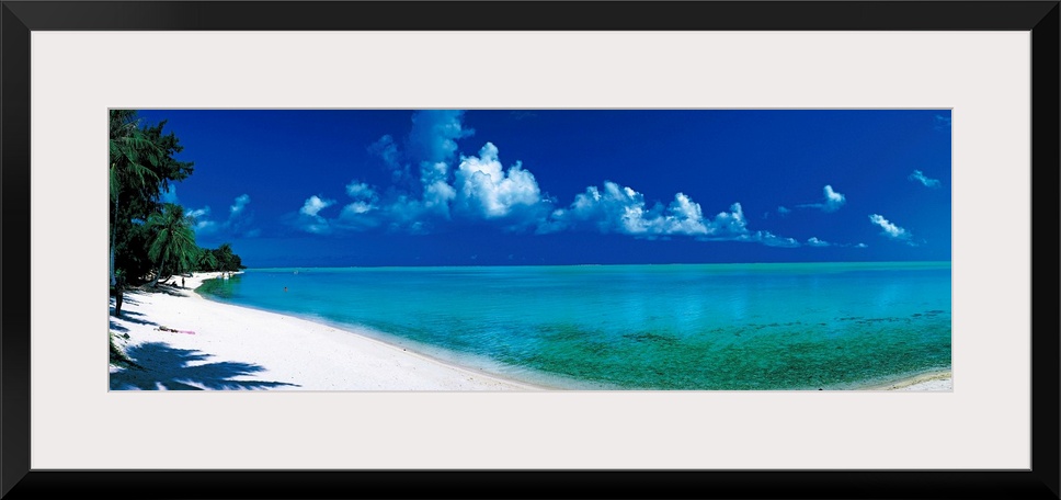 Oversized wall hanging of a sunlit shoreline in Bora Bora, Polynesia with calm waters leading into the horizon.