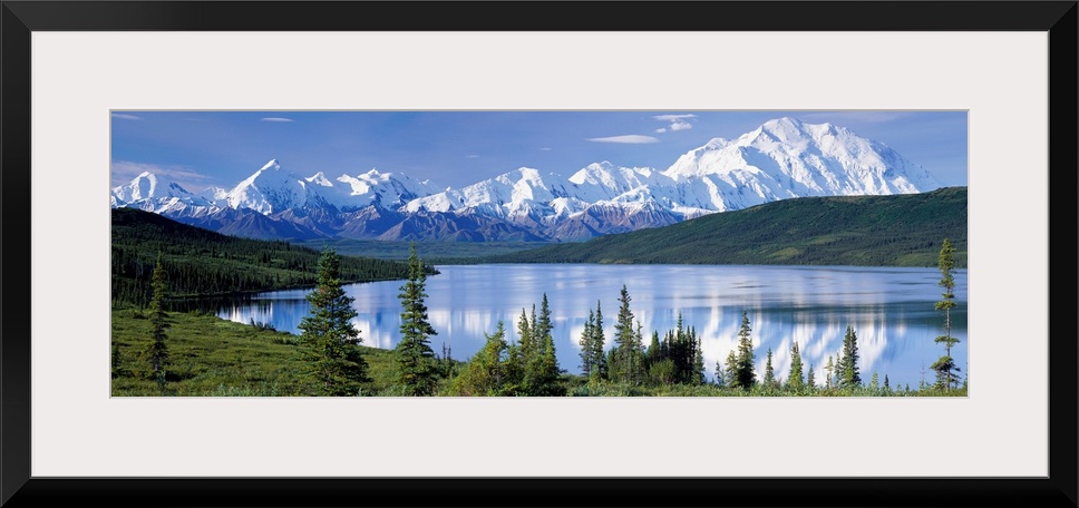 Panoramic photograph shows a landscape filled with trees as they surround and reflect into a lake within the Northwestern ...
