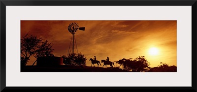 Silhouette of two horse riders at sunset, Hunt, Kerr County, Texas