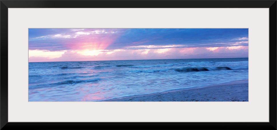 Large panoramic photo of the sun setting over a beach in Naples, Florida (FL).