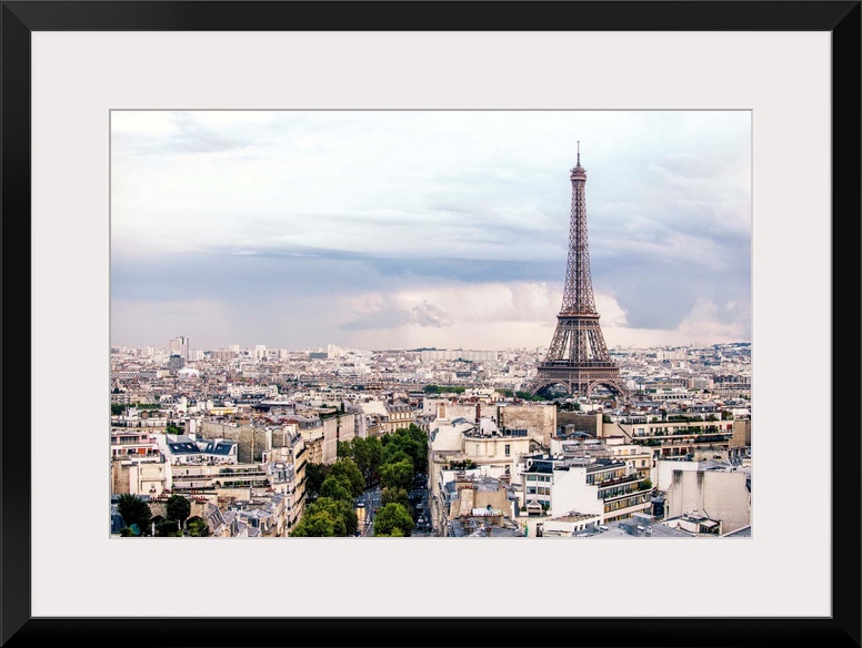 Aerial photograph of a Paris cityscape with the Eiffel Tower towering over all the buildings.