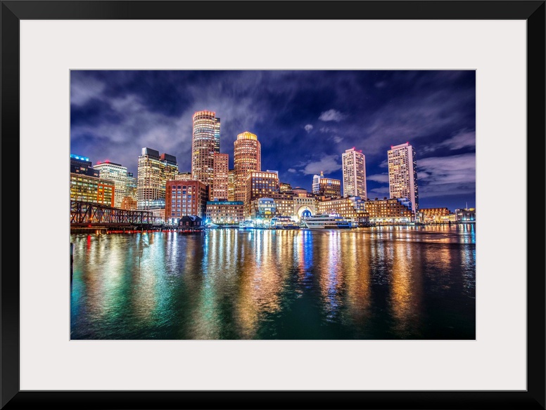 The lights of downtown Boston reflect upon Massachusetts Bay.