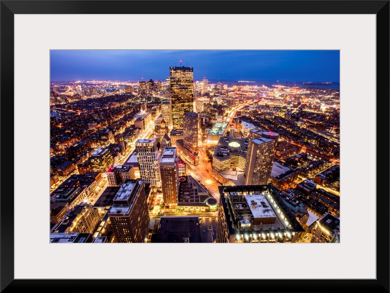 Aerial view of the city of Boston, Massachusetts, lit up at night.