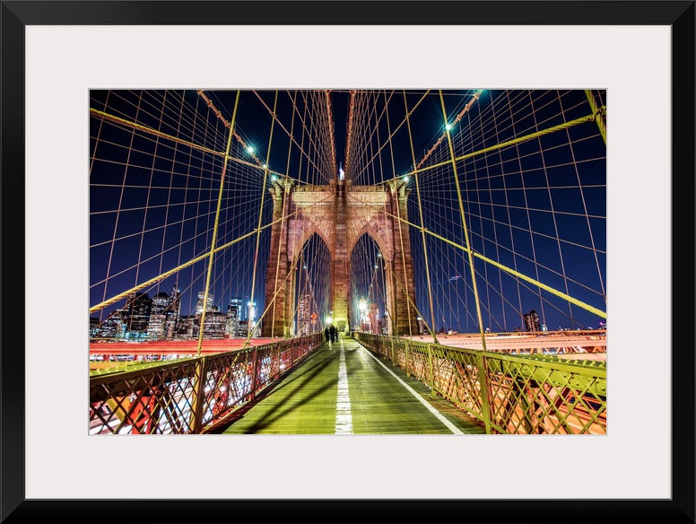 One of the stone piers surrounded by many cables on the Brooklyn Bridge in New York.