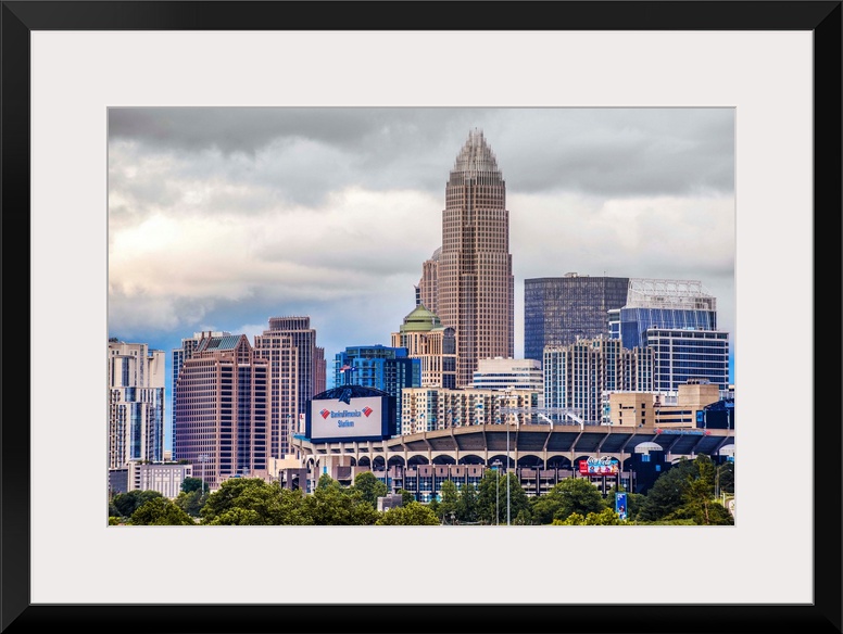 Horizontal image of the city of Charlotte, North Carolina with a cloudy sky.