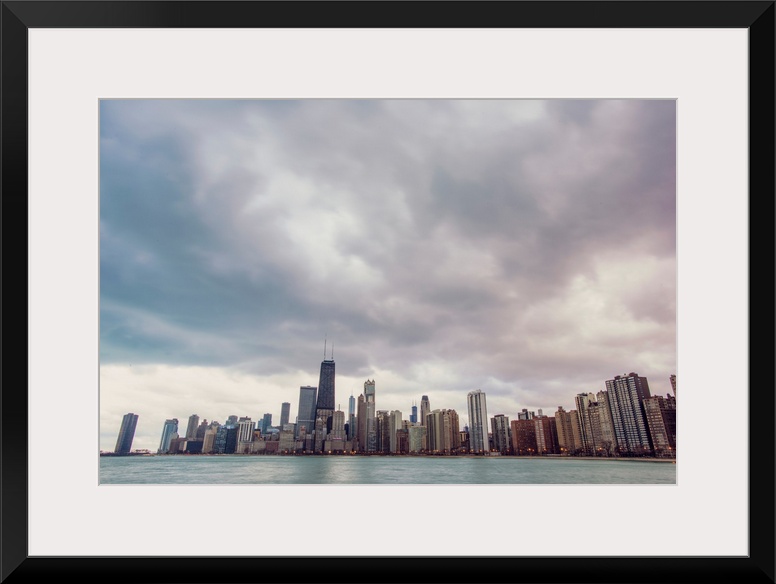 Photo of Chicago's skyline under dramatic clouds.