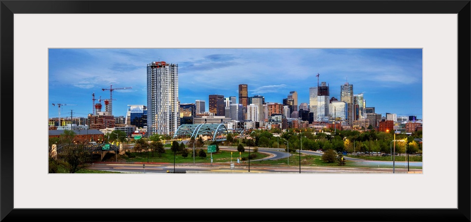 Photo of a Denver's skyline with light trails.