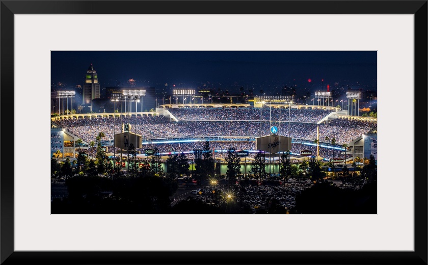 Panoramic photograph of Dodger Stadium lit up on a game night.