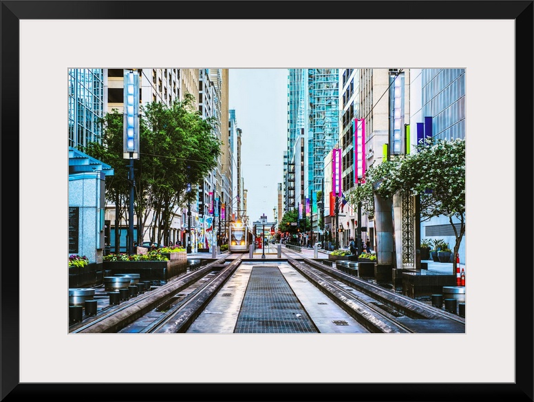 Downtown photograph of Houston TX with the METRORail coming down the center.