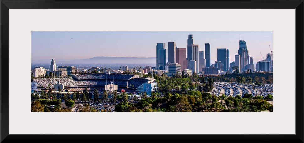 Panoramic photograph of the downtown Los Angeles skyline with Dodger Stadium on the left.