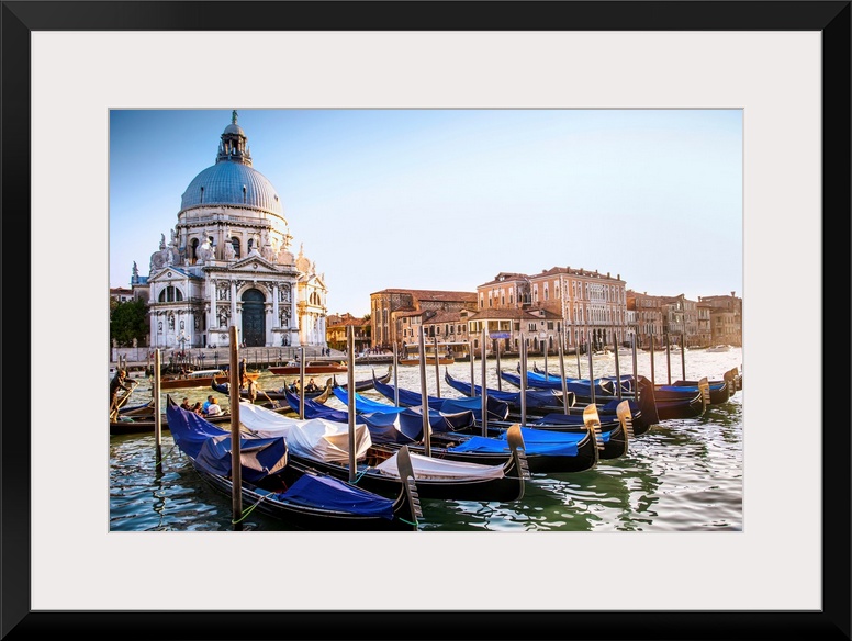 Photograph of gondolas lined up in a row in front of Santa Maria della Salute, Venice, Italy, Europe