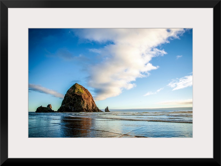 Panoramic photograph of Haystack Rock at golden hour, just before sunset, Cannon Beach, Oregon.
