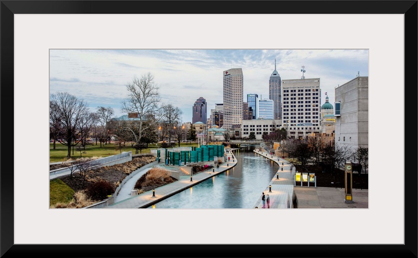 Photo of the Indianapolis city skyline reflecting onto the Indiana Central Canal.