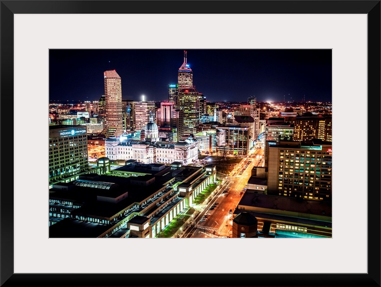 Skyscrapers illuminated at night with busy streets in Indianapolis, Indiana.