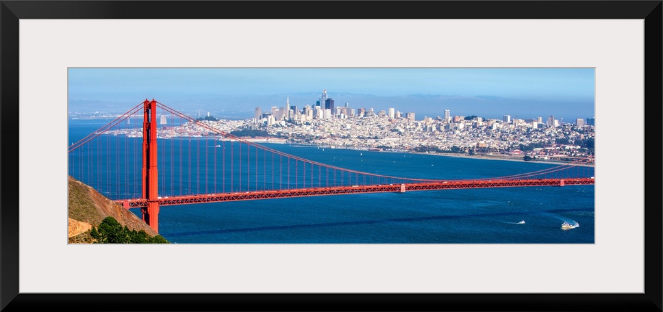 Panoramic photograph of the Golden Gate Bridge with San Francisco's skyscrapers in the background.