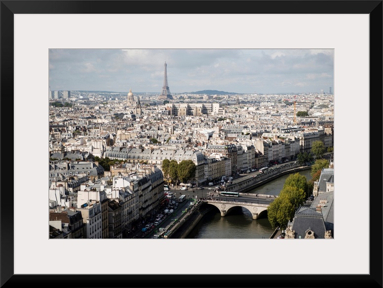 Photograph of a Paris Cityscape with the Eiffel Tower towering over the city.