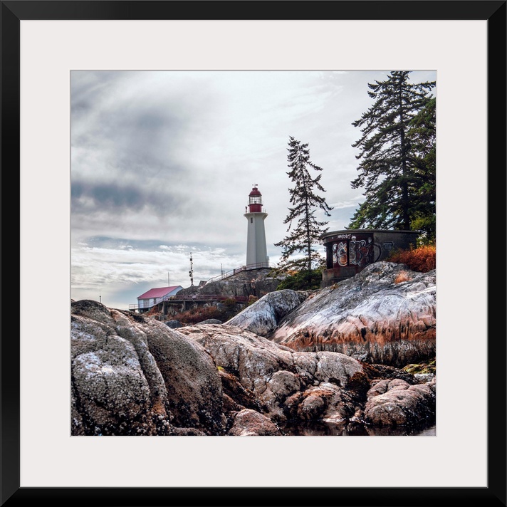 View of Point Atkinson Lighthouse and rocky shore in Vancouver, British Columbia, Canada.