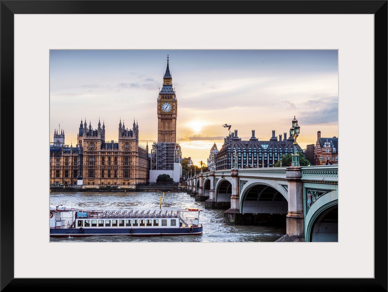 Photograph of a river boat on the River Thames about to go under the Westminster Bridge with Big Ben in the background.