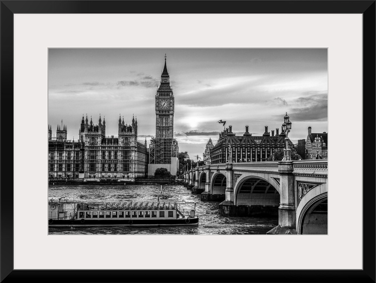 Photograph of a river boat on the River Thames about to go under the Westminster Bridge with Big Ben in the background.