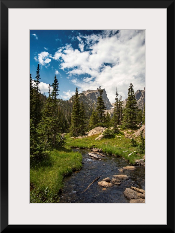 Landscape photograph of a stream going through Rocky Mountain National Park on a beautiful day.