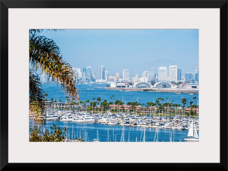 Panoramic photograph of the San Diego, California skyline with a marina in the foreground packed with sailboats.