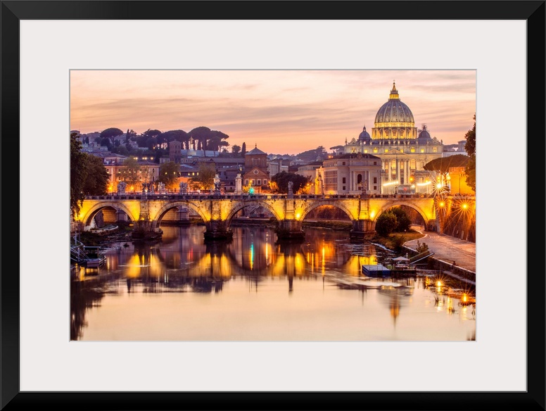 A view of St. Peter's Basilica in the Vatican and the Ponte Sant'Angelo  spanning across the river Tober in Rome, Italy at...