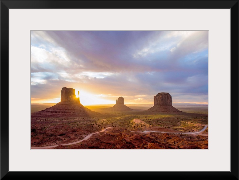 Sunrise at the Mittens and Merrick Buttes in Monument Valley, Arizona.