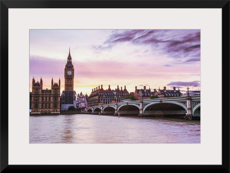 Photograph of Big Ben and the Westminster Bridge with a pink and purple sunset.