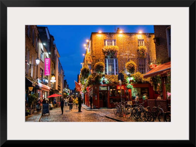 Photograph of Temple Bar, a busy riverside neighborhood in Dublin, Ireland, at night.