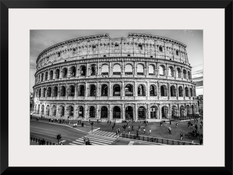 Photograph of the Colosseum lit up at dusk.