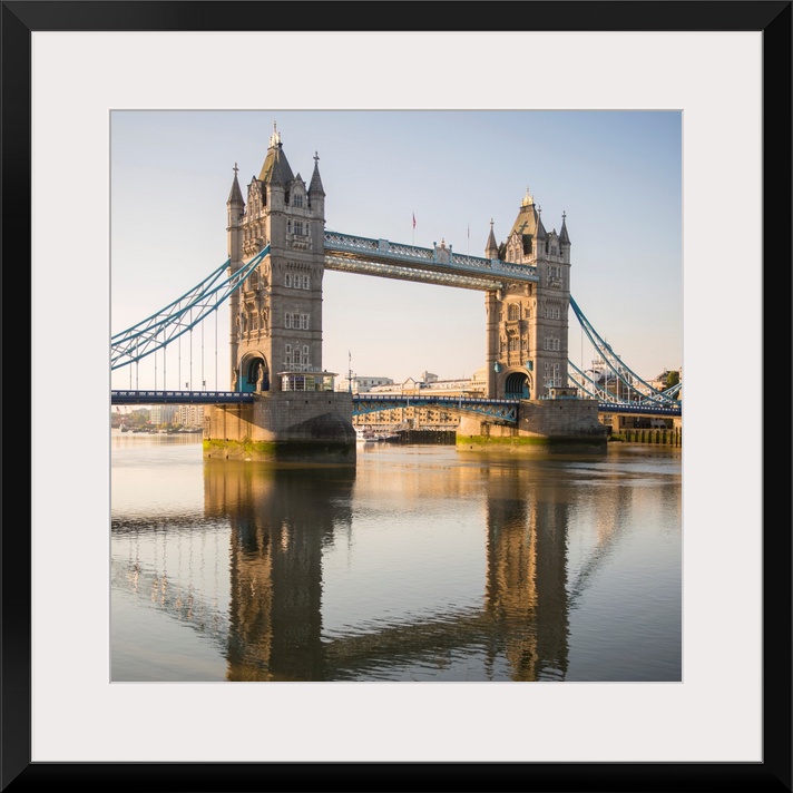 Square photograph of Tower Bridge reflecting into the River Thames in London, England, UK.