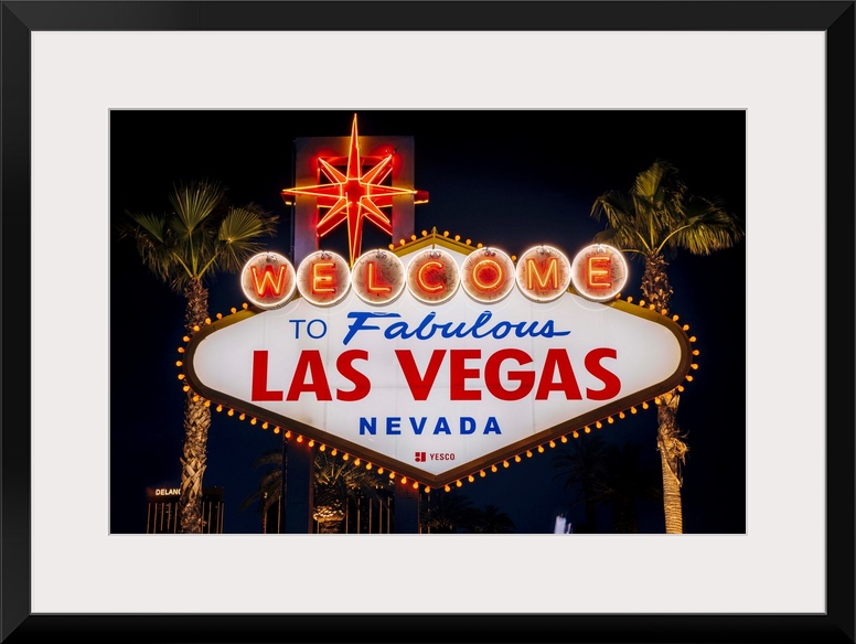 The famous "Welcome to Las Vegas, Nevada" sign is lit at night.