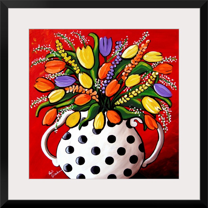 Fun, brightly colored polka dot vase filled with spring flowers and Tulips.