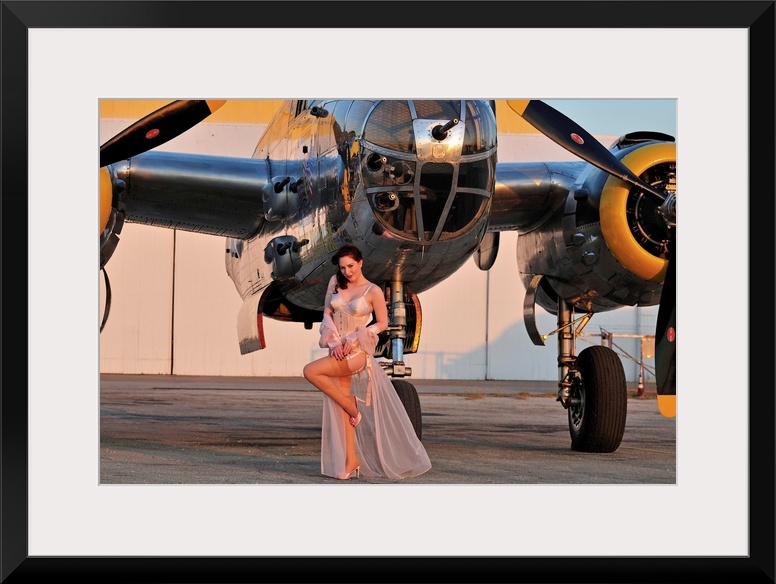 Sexy 1940's pin-up girl in lingerie posing with a B-25 bomber.