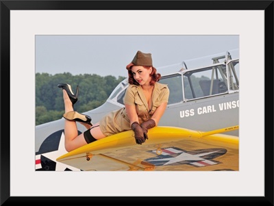 1940's style pin-up girl lying on a T-6 Texan training aircraft