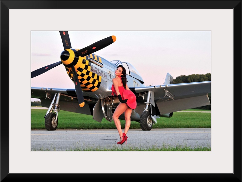 Sexy 1940's style pin-up girl posing with a P-51 Mustang fighter plane.