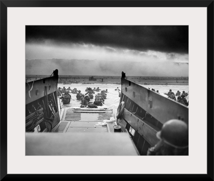 Digitally restored vintage World War II photo of American troops wading ashore on Omaha Beach during the D-Day invasion on...