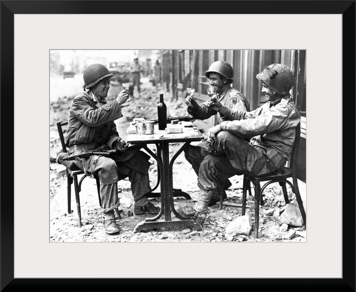 Three American soldiers at a sidewalk cafe in Paris, France, following the Allied liberation of the city, August 1944.