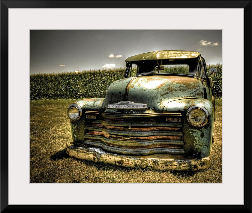 A photo on canvas of a vintage Chevrolet truck parked in front of a corn field.
