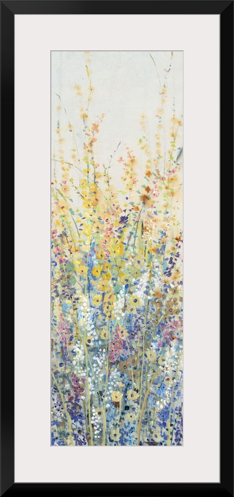 Vertical panel of blooming yellow and blue wildflowers in a field.