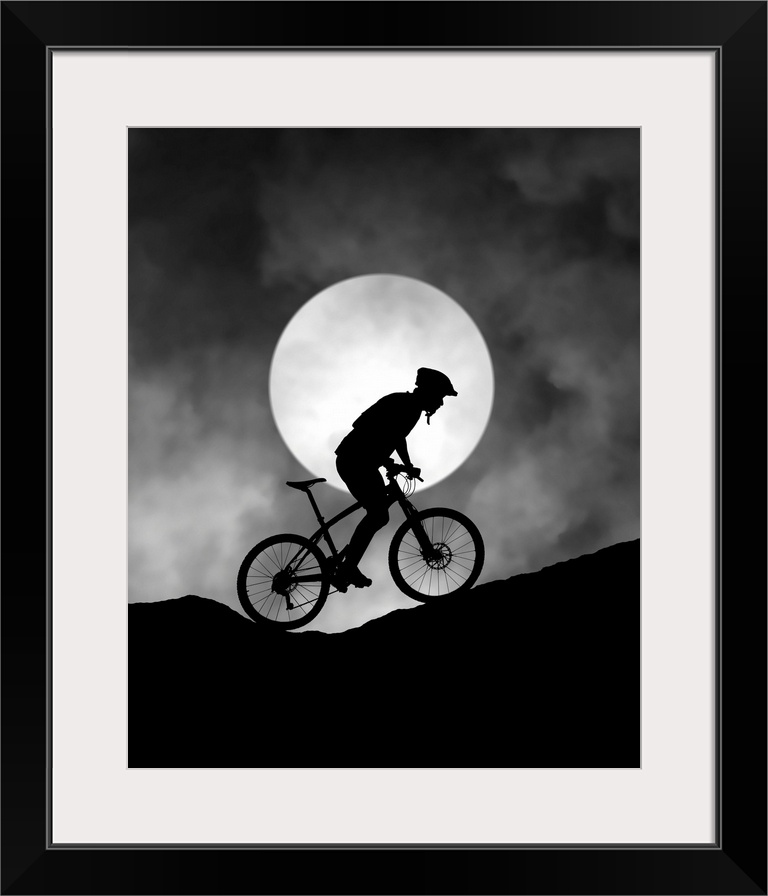 Silhouette of a biker pedaling up a hill, with the moon low in the sky.