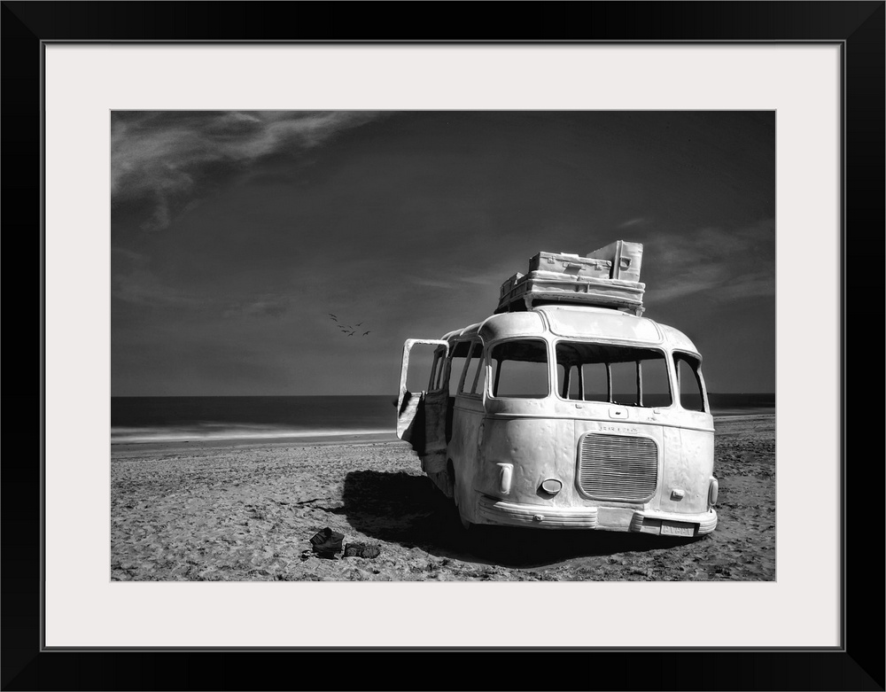 Black and white image of an abandoned bus with windows missing on a sandy beach in Belgium.