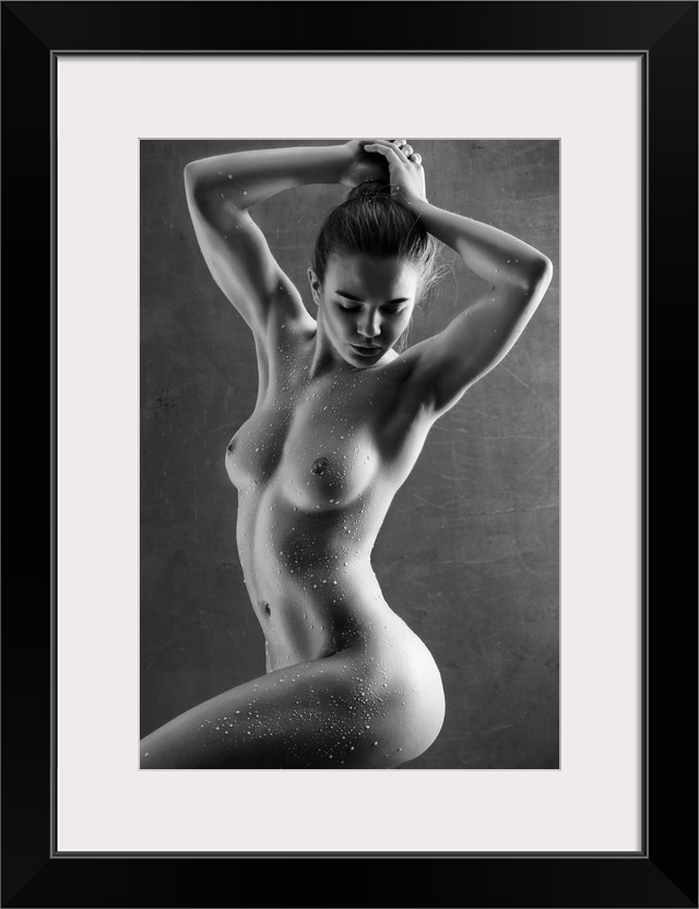 Elegant black and white fine art photograph of a nude woman posing with water drops all over her body.