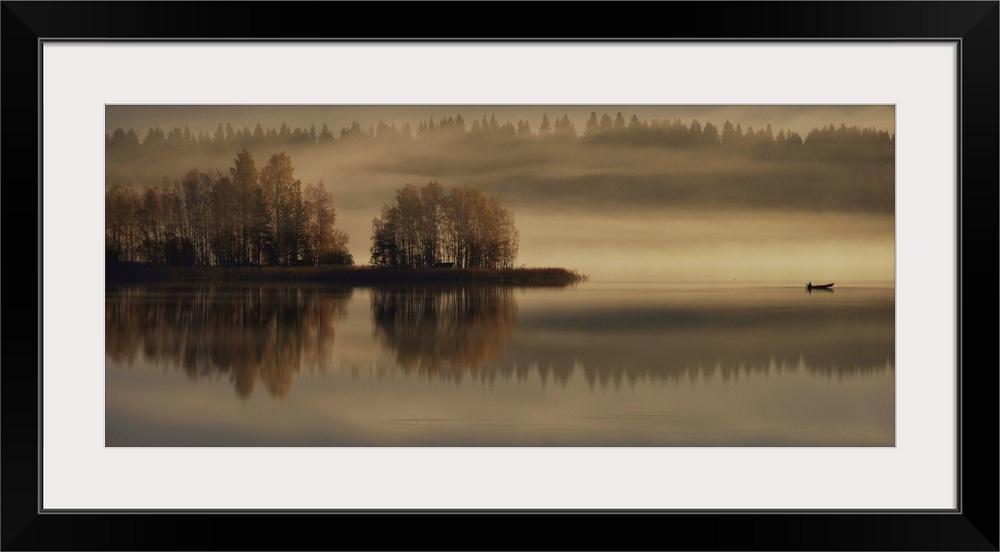 A photograph of an early autumn morning scene in the countryside, with fog hovering above the ground.