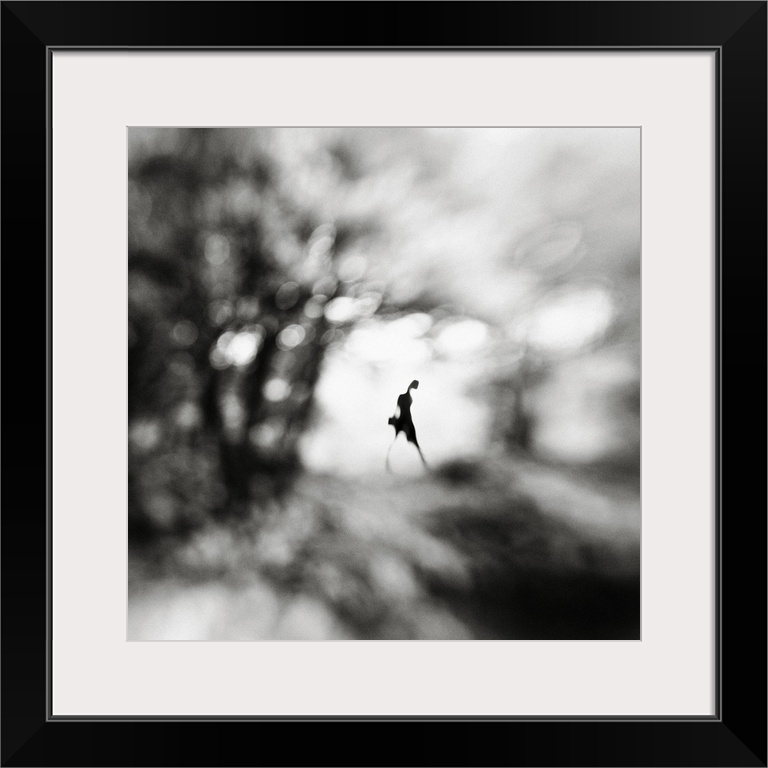 Conceptual image of a figure walking in a blurred landscape.