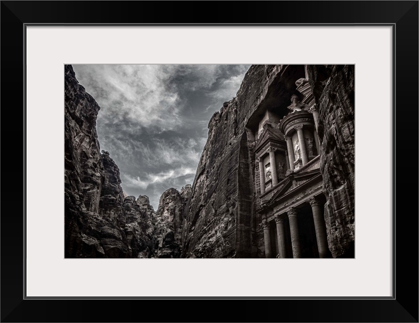 High contrast black and white image of the facade of the temple at Petra, Jordan.