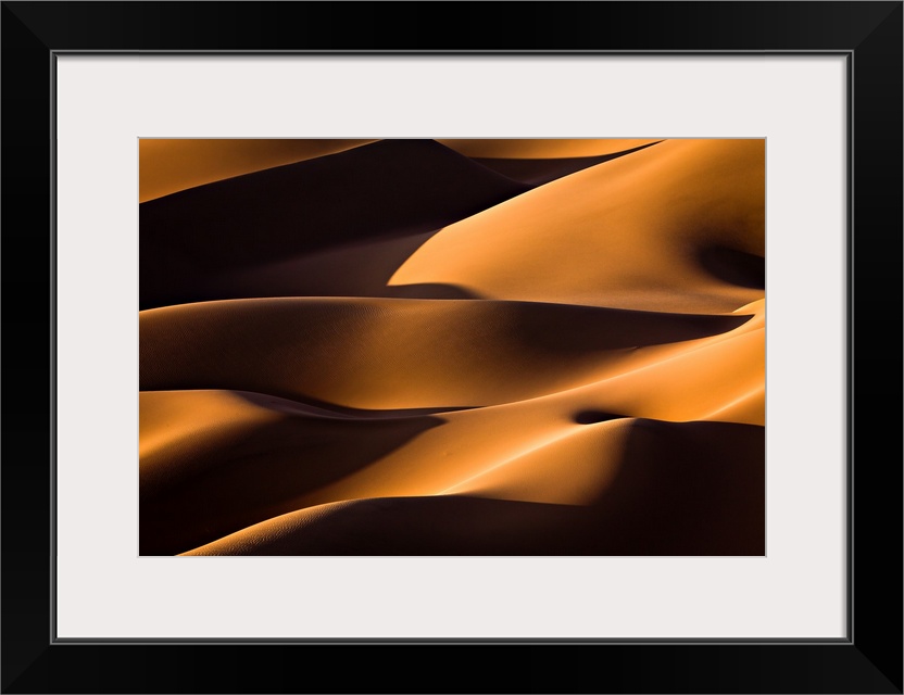 Dark shadows on the giant sand dunes of the Iranian desert.