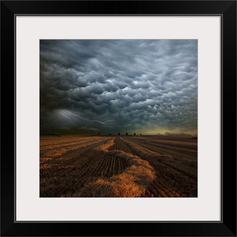 Strange storm cloud formations and lightning over farmland in Strohgaeu, Germany.