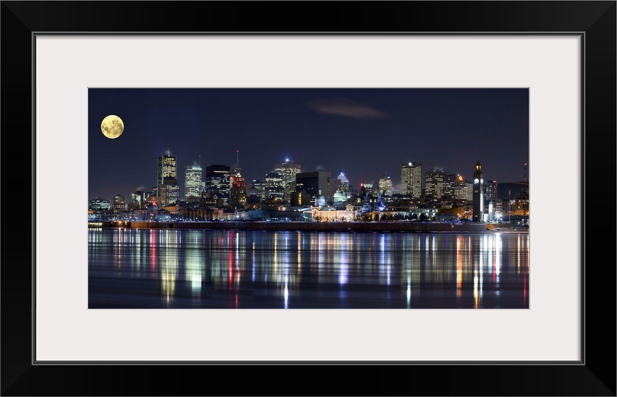 Colorful city lights of the Montreal skyline reflected in the water at night.