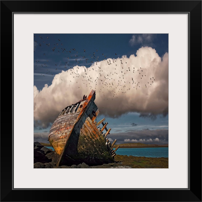 A derelict boat on shore of an Icelandic beach.